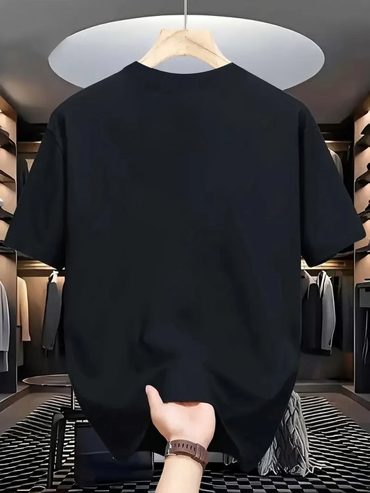 Black t-shirt on a hanger with a hand holding it in a clothing store.