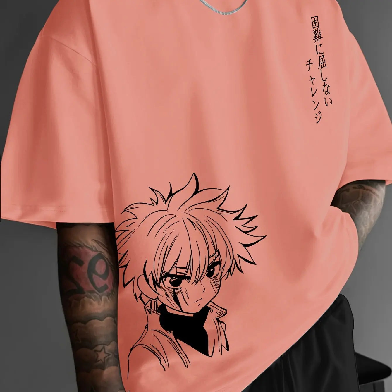 Person wearing a peach-colored t-shirt with an anime character design and text.
